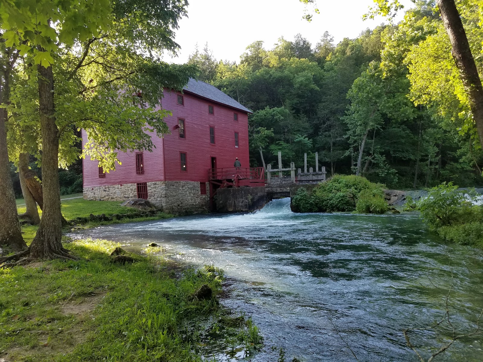 Red mill building by a river