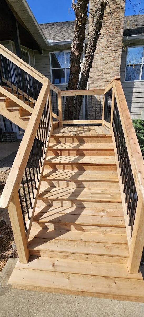 Wooden staircase with black railings